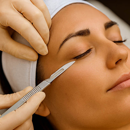 Licensed esthetician performing a dermaplaning treatment using a #15 surgical blade in a professional spa setting, demonstrating safe exfoliation technique for smoother, radiant skin