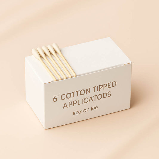 ox of 100 six-inch cotton tipped applicators used by estheticians for facials, extractions, and skincare treatments, displayed on a soft neutral background with clean spa-inspired lighting