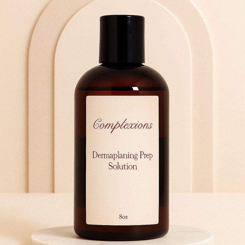 Luxury amber bottle of Complexions Dermaplaning Prep Solution displayed on a beige marble spa surface with soft lighting, professional skincare packaging for estheticians