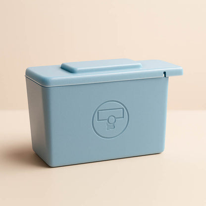 Blue surgical blade remover box for estheticians used to safely dispose of dermaplaning blades in professional skincare treatments.