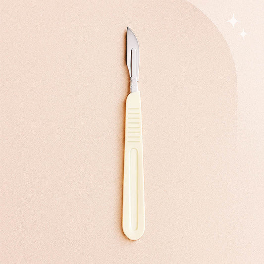 Luxury disposable dermaplaning blade handle with attached surgical blade displayed on a champagne satin background — elegant, high-end spa aesthetic ideal for estheticians and skincare professionals, optimized for Shopify product listings