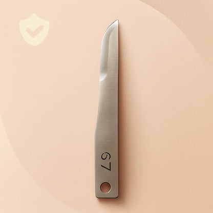Luxury #67 surgical dermaplaning blade displayed on a champagne satin background — polished stainless steel with engraved “#67,” showcasing precision craftsmanship and professional-grade quality for estheticians and skincare specialists, styled for high-end Shopify product listings