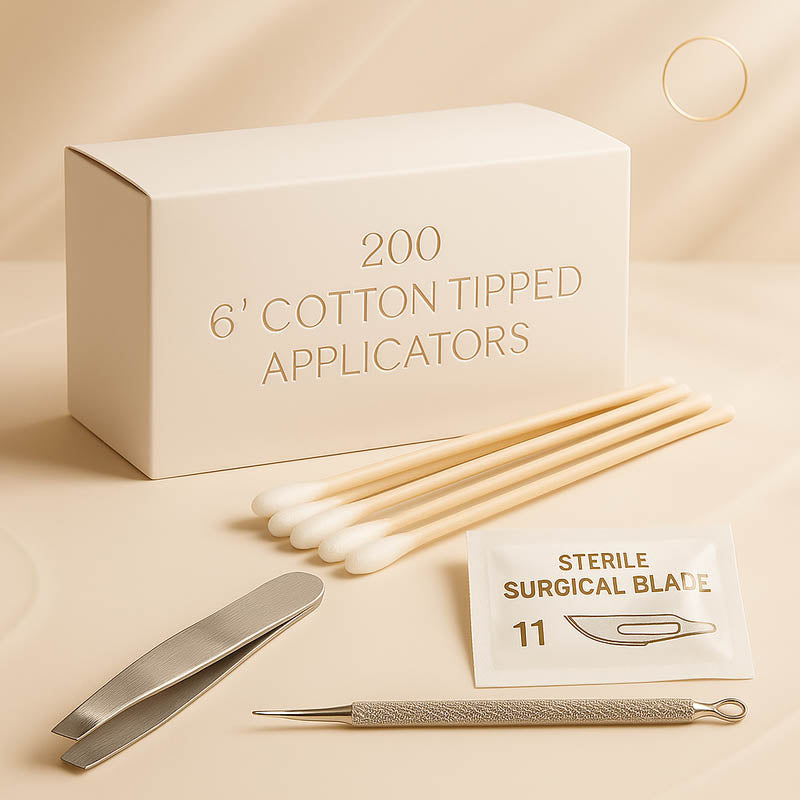 Luxury professional acne extraction kit for estheticians displayed on a soft champagne satin background — featuring a box labeled “200 6-inch cotton tipped applicators,” sterile surgical blade, stainless steel tweezers, and precision extraction tools, styled for a high-end spa aesthetic ideal for Shopify skincare product listings.