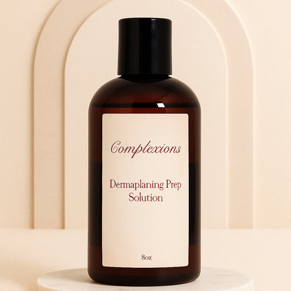 Luxury amber bottle of Complexions Dermaplaning Prep Solution displayed on a beige marble spa surface with soft lighting, professional skincare packaging for estheticians