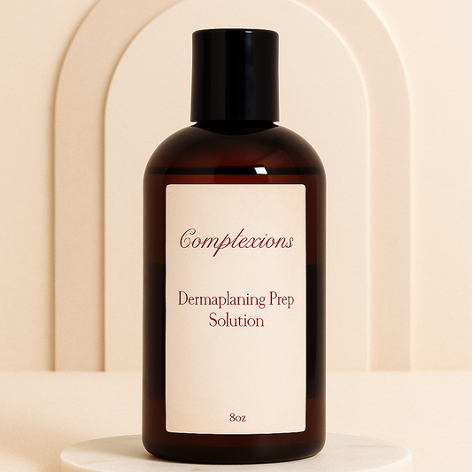 Luxury amber bottle of Complexions Dermaplaning Prep Solution displayed on a beige marble spa surface with soft lighting, professional skincare packaging for estheticians